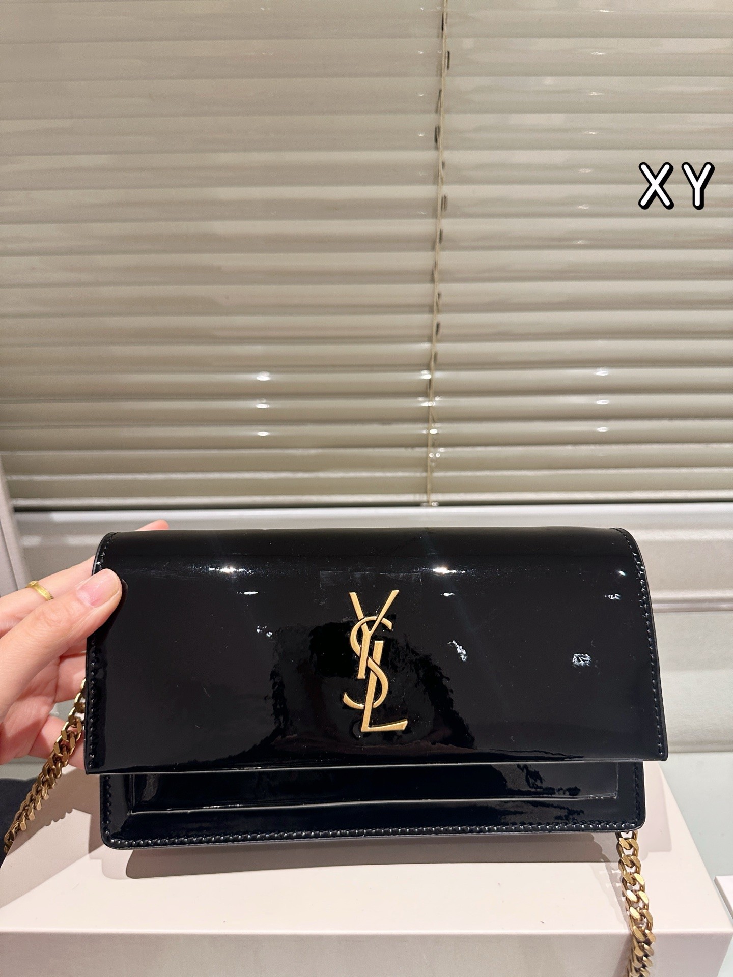 Sac à chaîne en cuir verni (Saint Laurent).